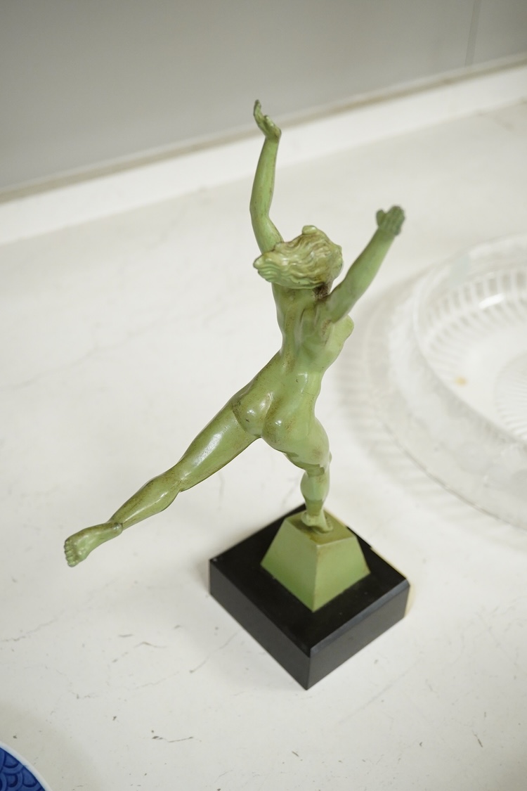 An Art Deco patinated spelter figurine of a nude dancer raised on black and green onyx base, 29cm high